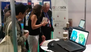 People discussing data analytics at a tech booth.