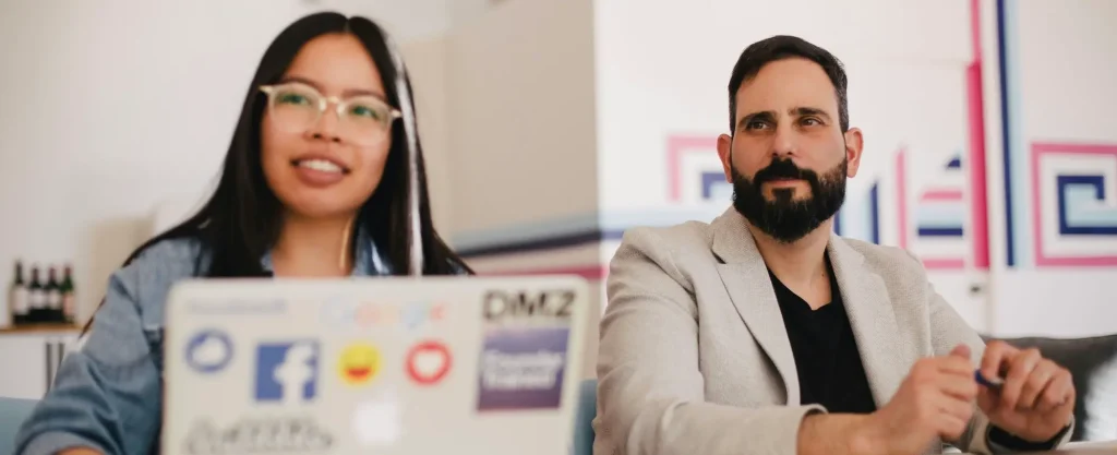 Two people working in a modern office space.