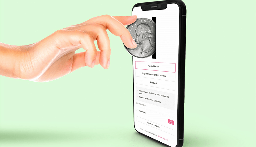 Coin entering smartphone for online payment.