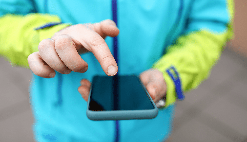 Person using smartphone with blue case