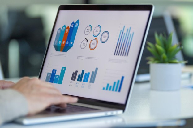 manual processing of data businessman working on a laptop with graphs and charts
