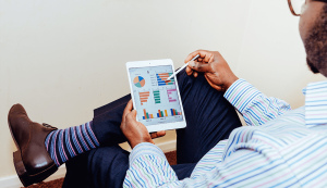 Person analyzing charts on a digital tablet.