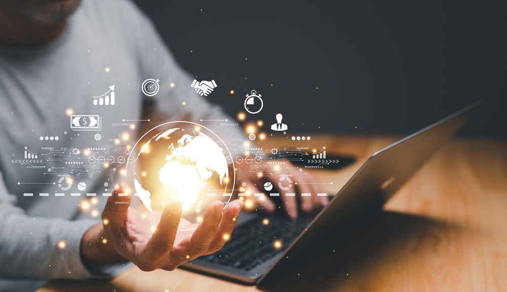 Digital globe with technology icons and laptop.