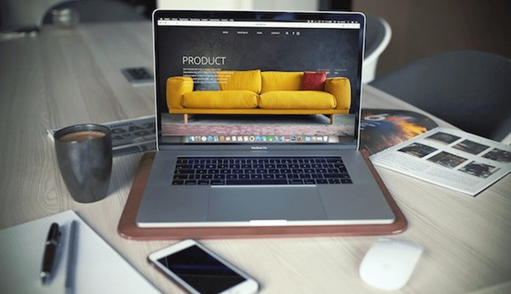 Laptop displaying yellow couch product webpage