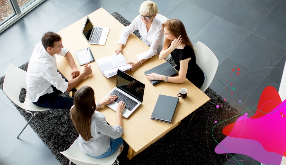 Business meeting with laptops and documents on table