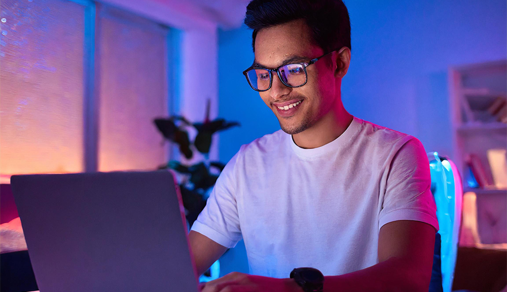 Man working on laptop in colorful room