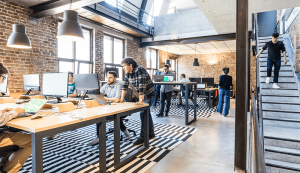 Modern office with people working collaboratively.