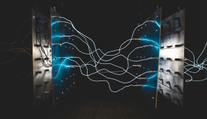 Glowing wires connect metal panels creating energy flow.