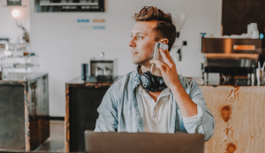 Person in cafe with phone and headphones