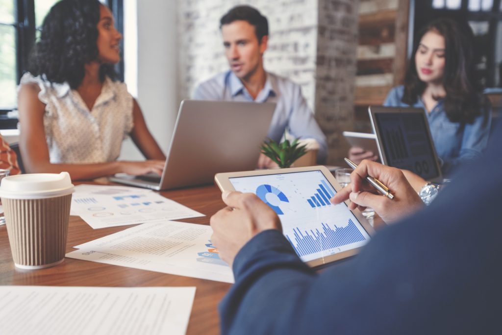 Marketing team monitoring business growth using data report