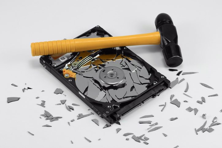 broken hard disk drive and hammer