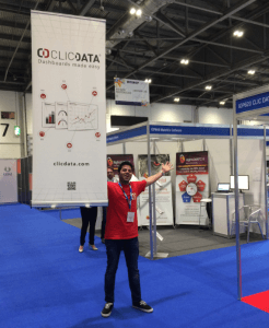 Shree proudly raising the ClicData banner to gather early visitors to our booth. 
